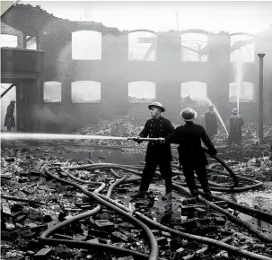  ??  ?? ABOVE Firemen dampening down fires in the Holbrooks area of Coventry following a Luftwaffe attack on December 3, 1940