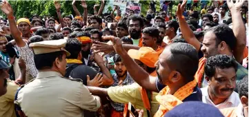  ?? — AFP photo ?? Indian policemen contain Hindu devotees and activist during a protest against the Supreme Court verdict revoking a ban on women’s entry to Sabarimala’s Ayyappa Hindu temple, in Nilackal in the southern Kerala.