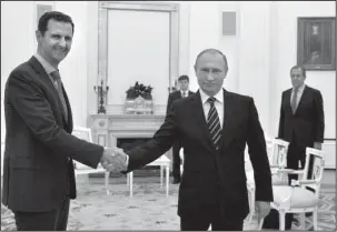  ?? The Associated Press ?? KREMLIN: In this Oct. 20, 2015, file photo, Russian President Vladimir Putin, center, shakes hand with Syrian President Bashar Assad as Russian Foreign Minister Sergey Lavrov, right, looks on in the Kremlin in Moscow, Russia. U.S. Secretary of State...