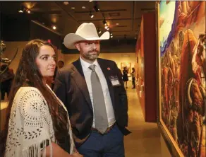  ??  ?? Visitors view a Kim Wiggins painting at the 2019 Masters of the American West. Photo by Danielle Klebanow.
February 8-March 22: Masters of the American West
AUTRY MUSEUM OF THE AMERICAN WEST | Los Angeles, CA | (323) 667-2000 | www.theautry.org