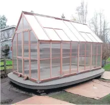  ??  ?? A hobby greenhouse is equipped with a timed irrigation system that automatica­lly turns on early in the morning to water plants. Smart devices are being introduced to make gardening less demanding.