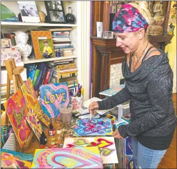  ??  ?? Freeman paints in her studio in Alameda.