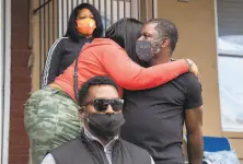  ?? Jose F. Moreno / Associated Press ?? Family and friends gather outside Walter Wallace Jr.’ s home last week after he was shot by police while armed with a knife.