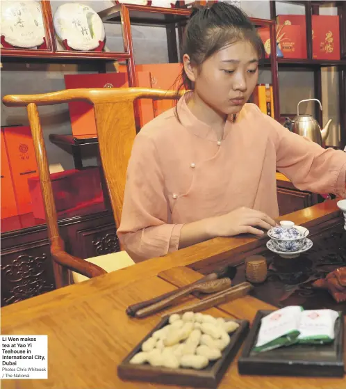  ?? Photos Chris Whiteoak / The National ?? Li Wen makes tea at Yao Yi Teahouse in Internatio­nal City, Dubai