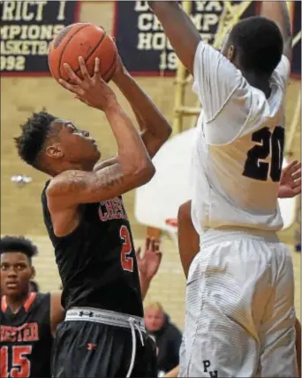  ?? PETE BANNAN — DIGITAL FIRST MEDIA ?? Chester’s Brian Randolph shoots as Penn Wood’s Vatangoe Donzo defends in the third quarter. Randolph scored a game-high 24 points as Chester notched a 57-46 win.