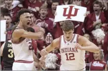  ?? AP photo ?? Indiana’s Trayce Jackson-Davis (left) celebrates with Miller Kopp during the first half of the Hoosiers’ 79-74 win over Purdue on Saturday.