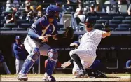  ?? Dustin Satloff / Getty Images ?? The Yankees’ Aaron Judge slides safely into home during the eighth inning on Monday against the Rangers.