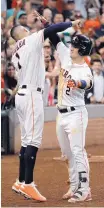  ?? DAVID J. PHILLIP/ASSOCIATED PRESS ?? Alex Bregman (2) celebrates with teammate Carlos Correa after hitting a home run on Saturday for the victorious Astros.