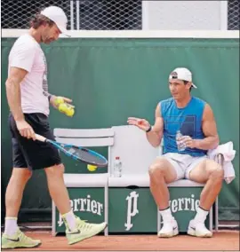  ??  ?? Rafa Nadal conversa con Carlos Moyá durante un entrenamie­nto.