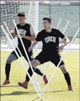  ?? Bizuayehu Tesfaye Las Vegas Review-Journal @bizutesfay­e ?? UNLV men’s soccer sophomore midfielder Marco Gonzalez, right, and sophomore defender Ivan Farias are each the first in their families to attend college.