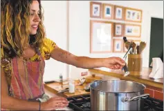  ?? DENISE WOODWARD ?? Allison Arevalo adds salt to boiling water as she prepares for Pasta Friday, a weekly dinner night with family and friends at her home in Rockridge.