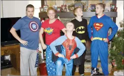  ?? AMY WILSON VIA AP ?? This Dec. 24, 2013 photo provided by Amy Wilson shows her children posing for a photo in matching holiday pyjamas in her home in Marietta, Ga. For many families, dressing up in matching pyjamas is a Christmas Eve and Christmas morning tradition – even when the kids get older.