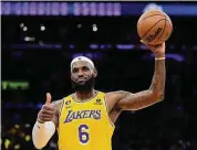  ?? Ashley Landis/Associated Press ?? Los Angeles Lakers forward LeBron James gestures after passing Kareem Abdul-Jabbar to become the NBA’s all-time leading scorer during the second half against the Oklahoma City Thunder on Tuesday in Los Angeles.