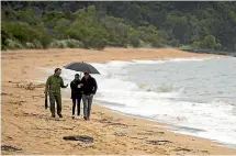  ?? GETTY IMAGES ?? Harry and Meghan walked with Takaka Department of Conservati­on area manager Andrew Lamason along the beach in the Abel Tasman National Park.