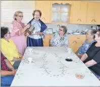  ?? ERIC MCCARTHY/JOURNAL PIONEER ?? Fairley Yeo, standing left and Betty Sweet get in a little practice serving their sister members of the Knutsford Women’s Institute as the group prepares for their Canada 150 Heritage Tea on Sept. 16. Waiting to be served, from left, are Barb Sweet, Verna Smallman, Orell Smallman, Harriet MacNeil and Susan Smallman.