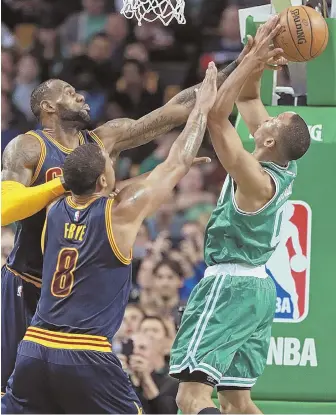  ?? STAFF PHOTO BY MATT STONE ?? NO WAY: LeBron James blocks a shot by Avery Bradley during the first half of last night’s game at the Garden.