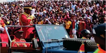  ?? ?? ▴His Majesty King Mswati III arriving at Mankayane Stadium and waving to the crowd.