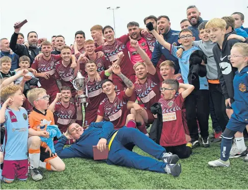  ?? ?? WINNERS: Dundee North End players celebrate after beating Carnoustie Panmure in the Quest Engineerin­g Cup final.