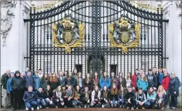  ??  ?? The pupils at the gates of Buckingham Palace.