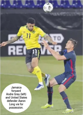  ??  ?? Jamaica forward Andre Gray (left) and United States defender Aaron Long vie for possession.