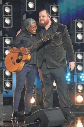  ?? ROBERT HANASHIRO/USA TODAY ?? Tracy Chapman and Luke Combs hug after performing “Fast Car” at the Grammy Awards in Los Angeles on Sunday.