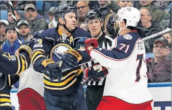  ?? [JEFFREY T. BARNES/THE ASSOCIATED PRESS] ?? The Sabres’ Josh Gorges, left, and the Blue Jackets’ Nick Foligno mix it up during the second period. First Period—