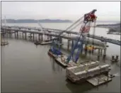  ?? JULIE JACOBSON - THE ASSOCIATED PRESS ?? A section of the Tappan Zee Bridge is lowered by floating crane onto a barge on the east end of the bridge Saturday in Tarrytown.