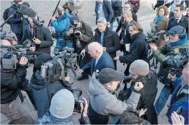  ?? JUSTIN TANG/The Canadian Press ?? Suspended senator Mike Duffy leaves an Ottawa courthouse after his first appearance Tuesday. The consensus is Duffy’s trial on 31 criminal charges, including fraud and bribery, could be Stephen Harper’s Waterloo, writes Michael Den Tandt.