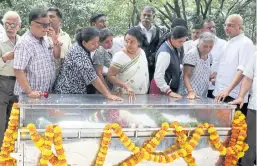  ??  ?? IN MEMORY: Relatives and friends stand next to the body of journalist Gauri Lankesh in Bangalore. Lankesh was a known critic of Hindu extremists.