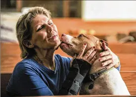  ?? THE DECATUR DAILY PHOTOS ?? Edee Grun said her grandson, Zye Tipton, is responsibl­e for saving Handsome, now 8, when he spotted him inside a shelter. Two years earlier, Handsome had been left to die in a dumpster before being rescued. “Handsome’s never left my side since” he entered her home.