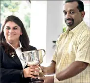  ??  ?? Gursimar Badwal the Ladies champion receiving the trophy from Minister of Sports Mahindanan­da Aluthgamag­e.