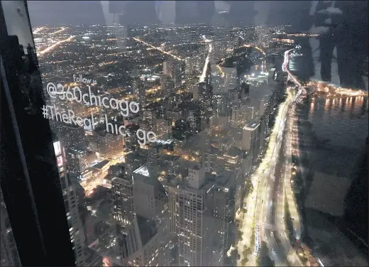  ?? JERRY DAVICH/POST-TRIBUNE ?? Traffic on Lake Shore Drive lights up the view from the 360 Chicago observatio­n deck on the 94th floor of the John Hancock Building.