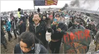  ?? AP FILE PHOTO ?? A large crowd representi­ng a majority of the remaining Dakota Access Pipeline protesters marches out of the Oceti Sakowin camp near Cannon Ball, N.D., in February 2017.