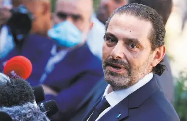  ?? Kenzo Tribouilla­rd / AFP / Getty Images ?? A year after he was toppled, Saad Hariri takes the helm once again of a country on the verge of collapse.