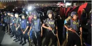  ?? - AP/PTI ?? ON GUARD: Bangladesh police stand guard after an attacker was killed in front of a police box at the entrance to Dhaka’s internatio­nal airport on Friday.