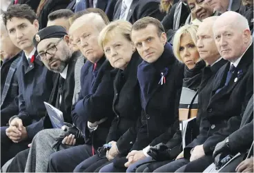  ?? LUDOVIC MARIN / POOL PHOTO VIA AP ?? At a ceremony at the Arc de Triomphe, from left, Prime Minister Justin Trudeau, Moroccan King Mohammed VI, U.S. President Donald Trump, German Chancellor Angela Merkel, French President Emmanuel Macron and wife Brigitte Macron, Russian President Vladimir Putin and Australian Governor-General Peter Cosgrove.