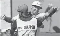  ??  ?? Kevin Chappell gets a hug from his caddy after sinking a birdie on the 18th hole to win the Valero Texas Open tournament Sunday in San Antonio.