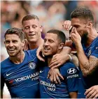  ??  ?? Left, Roberto Firmino and Mo Salah celebrate for Liverpool while Eden Hazard, of Chelsea, was the centre of the attention as they beat Cardiff 4-1.