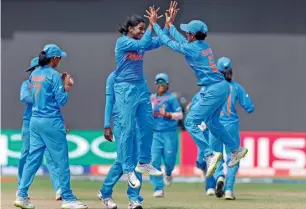  ?? PTI ?? Indian women cricketers celebrate taking a Pakistani wicket during the Group B clash. —