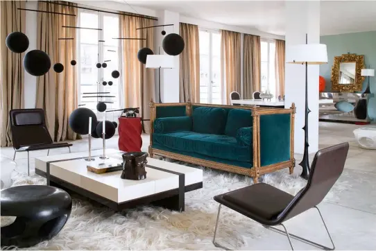  ??  ?? CLASS ACT A Louis XVI sofa is the sole classical element in this Parisian apartment’s living area. The Capsule footstool, Mondrian coffee table, Epines floor lamps and pot sculpture are all by Hervé Van der Straeten. The mobile is by Xavier Veilhan