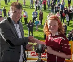  ??  ?? Aoife Mahon receives the trophy from Jim Dempsey (Rackard League).