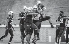  ?? ANDREW DYE/WINSTON-SALEM JOURNAL VIA ASSOCIATED PRESS ?? Wake Forest defensive back Nick Andersen (45) is congratula­ted by teammates after intercepti­ng a pass in the end zone. Andersen had three picks on the day.