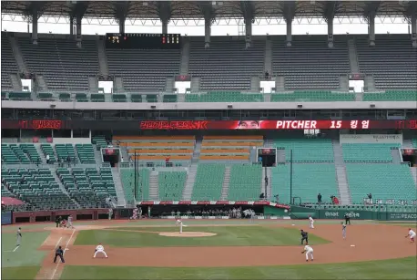  ?? LEE JIN-MAN — THE ASSOCIATED PRESS ?? Scenes like this game from the Korean Baseball Organizati­on between the Hanwha Eagles and the SK Wyverns give a glimpse of what baseball will look like once the MLB season begins.