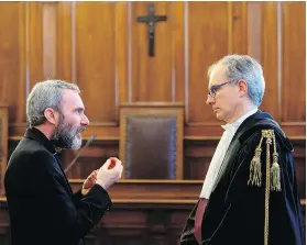  ?? VATICAN MEDIA/ANSA VIA THE ASSOCIATED PRESS ?? Former Holy See diplomat Msgr. Carlo Alberto Capella, left, talks with his lawyer at a Vatican tribunal on Saturday.