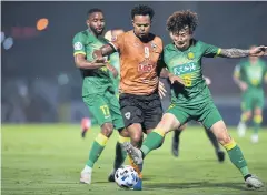  ??  ?? Chiang Rai striker Bill Rosimar, centre, in action against Beijing.