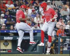  ?? Associated Press ?? Los Angeles Angels third base coach Eric Young Sr., left, and Zach Neto (9) celebrate after a solo home run by Neto who rounds the bases during the sixth inning of a game against the Houston Astros on Monday in Houston.