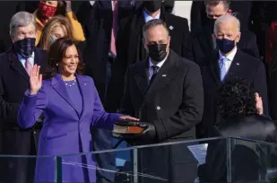  ?? ALEX WONG/GETTY IMAGES ?? Kamala Harris is sworn in as vice president by U.S. Supreme Court Associate Justice Sonia Sotomayor as her husband Doug Emhoff looks on at the inaugurati­on of U.S. President Joe Biden at the U.S. Capitol in Washington, D.C. on Wednesday.