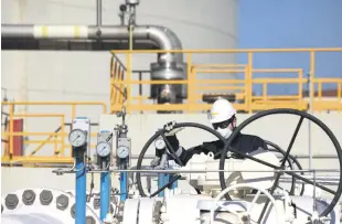  ?? ?? An employee works at an LNG terminal in Aliağa, İzmir, western Türkiye, Feb. 18, 2022.