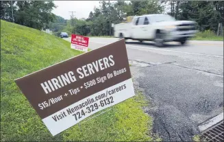  ?? GENE J. PUSKAR — THE ASSOCIATED PRESS FILE ?? Help wanted signs for servers and cooks at Nemacolin Woodlands Resort and Spa at the entrance to the resort in Farmington, Pa. U.S. employers advertised more jobs but hired fewer workers in July, sending mixed signals about a job market in the wake of the coronaviru­s outbreak.