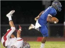  ?? RICK KAUFFMAN — DIGITAL FIRST MEDIA ?? Dazhon Miller, right, gained valuable yards for Academy Park after West Chester East’s Matt Erfle missed a tackle.